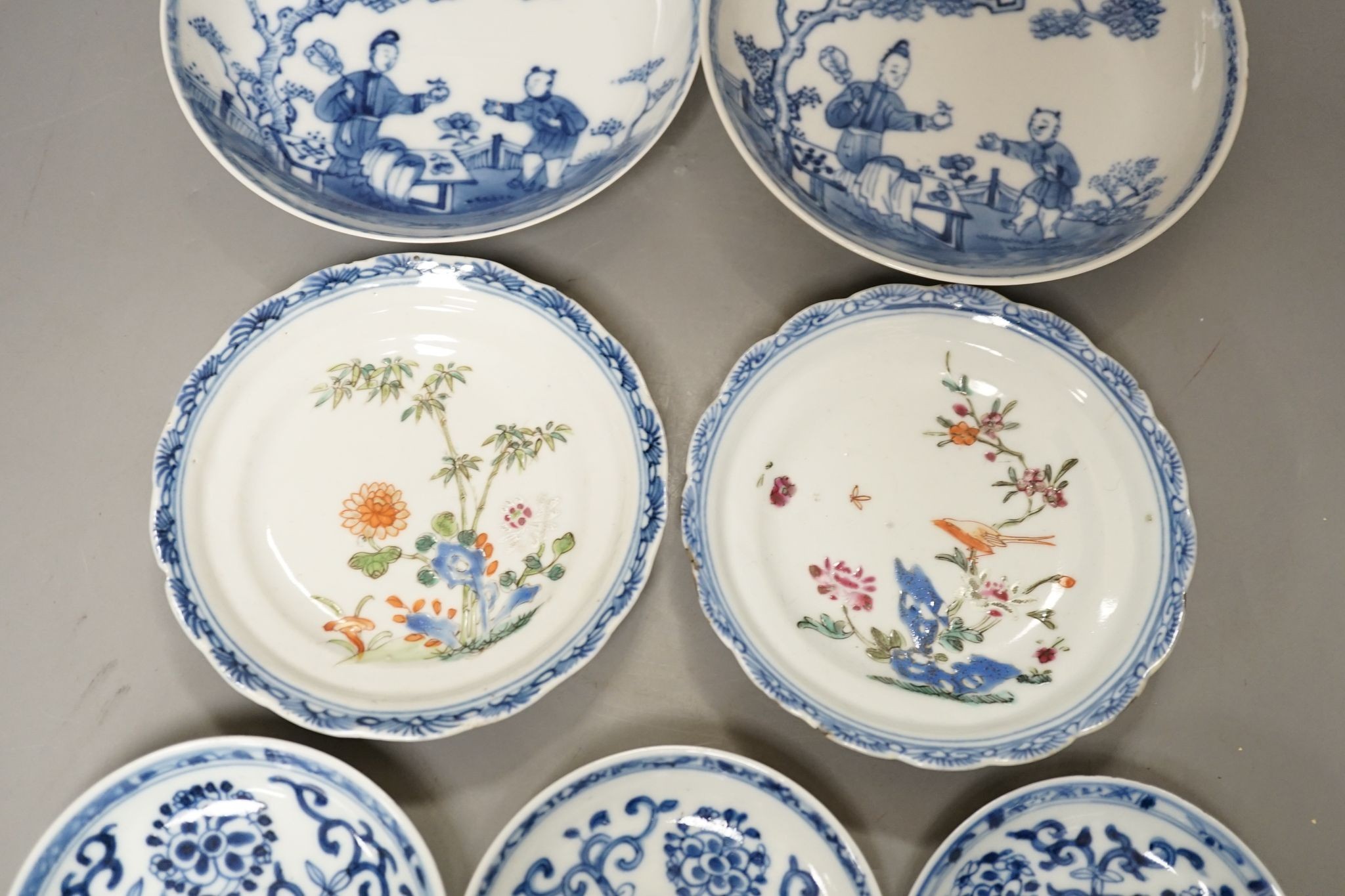 Seven 18th century Chinese saucer dishes, largest 14 cms diameter.